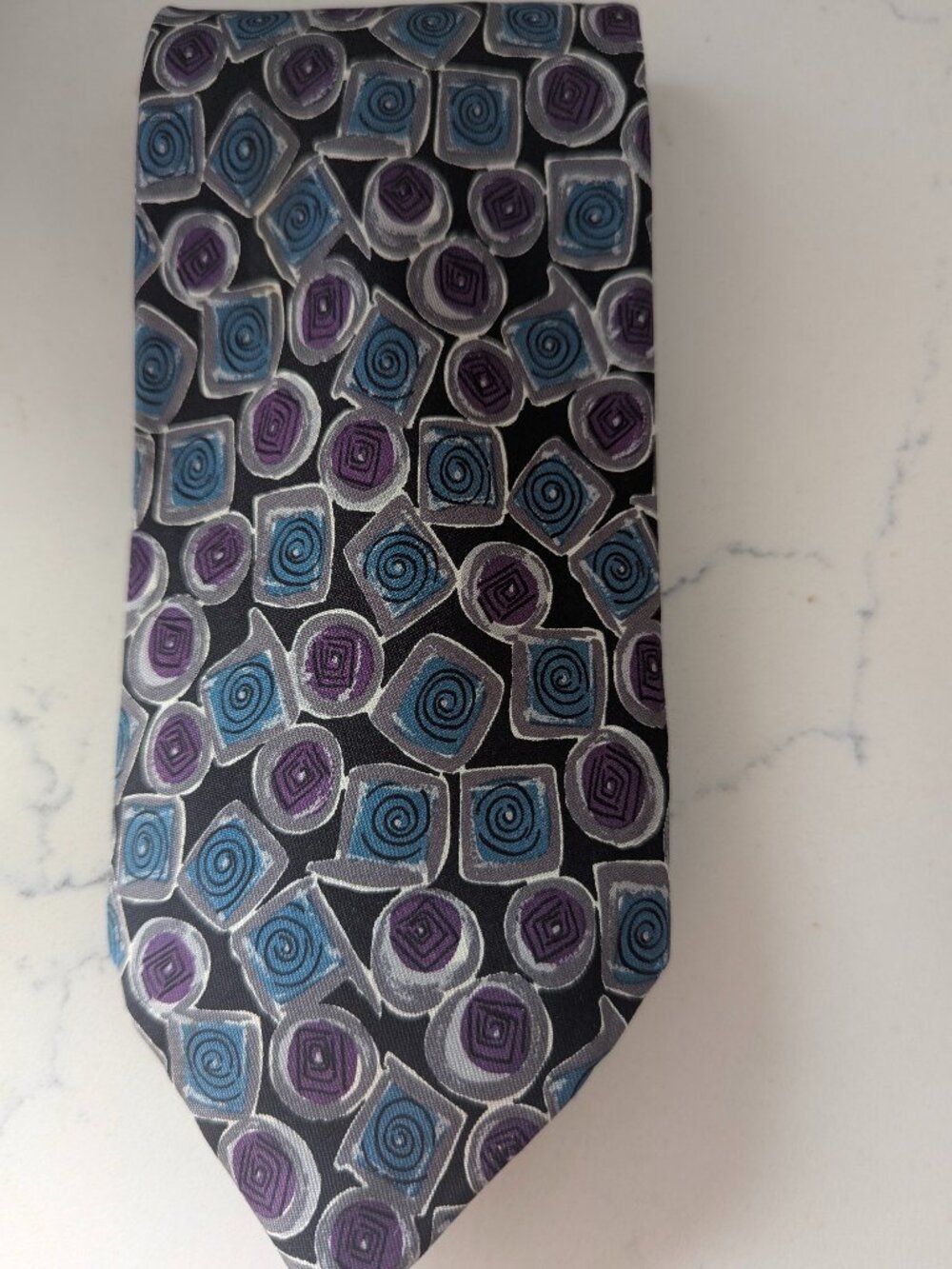 This Robert Talbott Studio tie 100% silk Purple geometric spiral pattern 3.5"